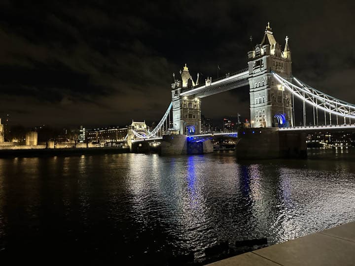 A photograph from the southern side of the Thames looking northward at Tower Bridge photographed at night, this is a popular location for visiting London. A popular bespoke London tour location.